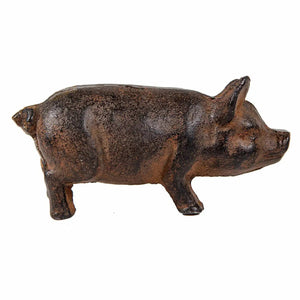 Rustic brown and black cast iron pig sculpture with a textured surface, facing right.