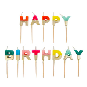 Rainbow Happy Birthday candles from Talking Tables USA, colorful wax candles arranged for birthday celebration decor.