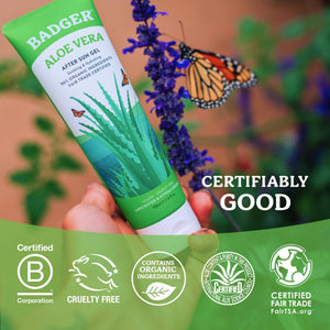 Badger Aloe Vera Gel for face and body, soothing sunburn relief, in a clear tube with green accents, showing fresh aloe vera leaves.