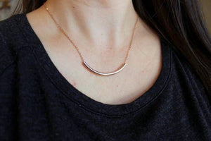 Laalee Jewelry curved tube necklace showcasing sleek, modern silver jewelry with a smooth, curved design.