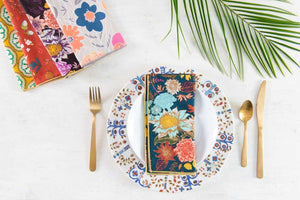 Set of four winter floral cloth dinner and cocktail napkins by Dot and Army, featuring elegant floral patterns.