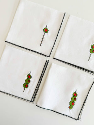 Set of four white Martini Olive Cloth Cocktail Napkins by Dot and Army, soft fabric with olive pattern for elegant table settings.