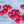 Decorative glass pocket hearts in three color schemes, made by SHOPGIVECOURAGE, displayed in a close-up image.