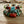 Multicolored beaded bracelets with blue, green, red, and gold beads on a wooden surface.