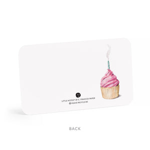 White card with a pink frosted cupcake and blue candle on the right side. Text below.