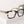 Peepers Spotlight reading glasses with clear lenses and stylish black frames, close-up of the eyewear on a white background.