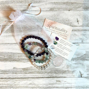 Set of three spiritual bracelet jewelry pieces with intentional charms, featuring natural stones and earthy elements for mindfulness.
