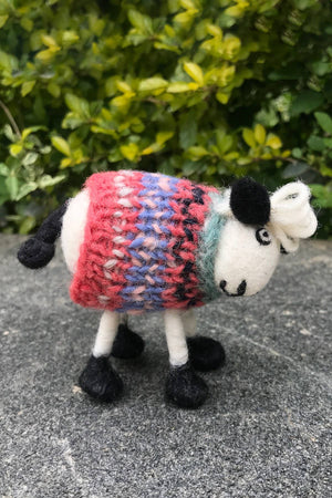 Hand-felted wool sheep decor from Pachamama Ltd's DECOR-Tank Top Tracey, a cute wool sheep home decoration on a pleasant beach setting.