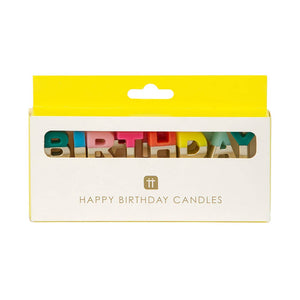 Rainbow happy birthday candles from Talking Tables USA arranged for a festive birthday cake display.