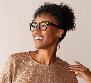 Peepers reading glasses with transparent frames and clear lenses, stylishly displayed on a white background.