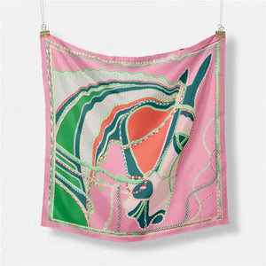 Abstract horse design on a pink silk scarf with green, white, and orange accents.