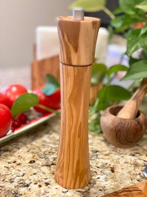 Olive wood pepper mill from Natural OliveWood, showcasing a handcrafted kitchen pepper grinder with a smooth, natural wood finish.