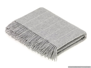 Soft Merino Lambswool throw from Bronte Moon's Classic Collection, displayed with matching pillows in cozy, textured fabric.