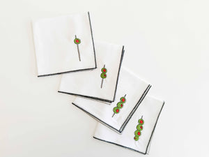 Set of 4 white Martini Olive Cloth Cocktail Napkins by Dot and Army, featuring elegant olive print design.