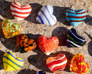 Decorative glass pocket hearts in three color schemes, featuring transparent and colorful glass designs by SHOPGIVECOURAGE.