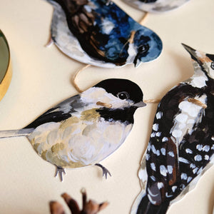 Doro Marcello bird-themed paper garland, 24 inches, botanical wall art with colorful bird and leaf paper cutouts hanging in a decorative display.
