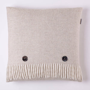Bronte Moon Classic Collection Merino Lambswool blanket draped over a sofa with matching pillows, showcasing soft, cozy wool texture.