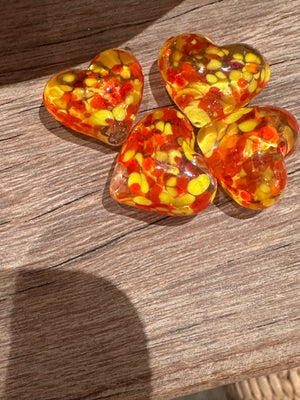 Glass pocket hearts in three color schemes by SHOPGIVECOURAGE, displayed in a close-up image showing vibrant, transparent glass hearts.