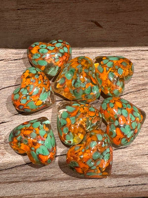 Glass pocket hearts in three color schemes from SHOPGIVECOURAGE, showcasing vibrant, decorative glass heart accents.