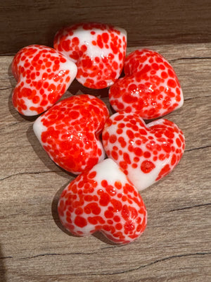 Glass pocket hearts in three color schemes, decorative home accents by SHOPGIVECOURAGE, shown in a close-up image.