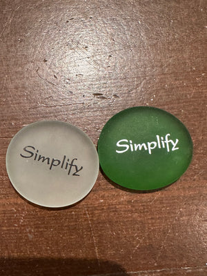 Imprinted glass word stones from SHOPGIVECOURAGE displayed in a bowl, showcasing inspirational messages and decorative design.