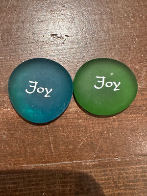 Imprinted glass word stones from SHOPGIVECOURAGE displayed in a bowl, featuring inspirational messages on clear, smooth stones.
