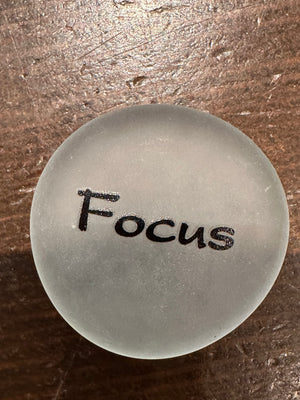 Set of 60 imprinted glass word stones from SHOPGIVECOURAGE displayed in a bowl, featuring inspirational messages on clear glass stones.