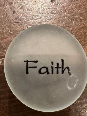 Imprinted glass Sea Stones with inspirational words in a bowl display, showcasing the SHOPGIVECOURAGE brand.