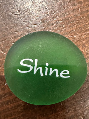 Imprinted glass word stones from SHOPGIVECOURAGE displayed in a bowl, featuring inspirational messages on smooth, colorful stones.