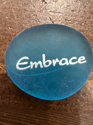 Sea stones with imprinted glass words displayed in a bowl, featuring 60 inspirational message stones by SHOPGIVECOURAGE.