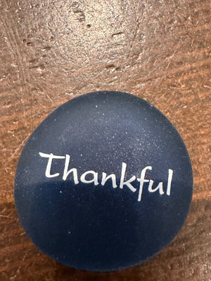 Imprinted glass word stones from SHOPGIVECOURAGE in a bowl display, featuring 60 decorative sea stones with engraved words.