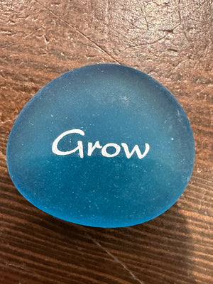 Set of 60 imprinted glass word stones from SHOPGIVECOURAGE displayed in a bowl for decorative or inspirational use.