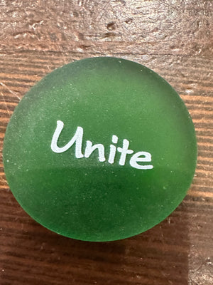 Imprinted glass word stones from SHOPGIVECOURAGE displayed in a bowl, featuring inspirational words on smooth, clear glass stones.