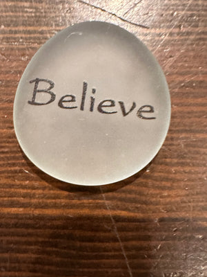 Imprinted glass word stones from SHOPGIVECOURAGE displayed in a bowl, featuring inspiring messages on clear, polished stones.