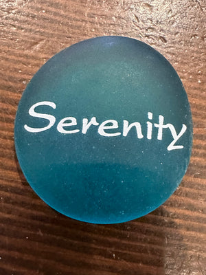 Sea stones with imprinted glass words displayed in a bowl, featuring 60 decorative SHOPGIVECOURAGE word stones.