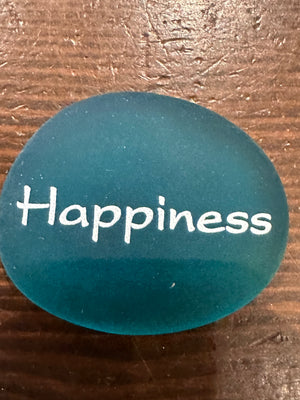 Imprinted glass word stones from SHOPGIVECOURAGE display in a bowl, featuring inspirational words on smooth, polished sea stones.