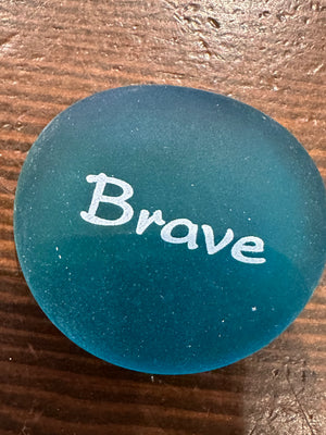Imprinted glass word stones from SHOPGIVECOURAGE, 60-piece set displayed in a bowl, featuring inspiring messages on smooth, clear stones.