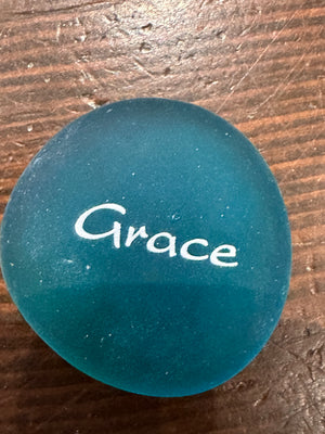 Imprinted glass word stones in a bowl display, featuring natural sea stones with inspirational messages, by SHOPGIVECOURAGE.