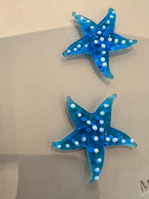 Miniature glass starfish figurine from SHOPGIVECOURAGE, decorative collectible with detailed, translucent glass design.
