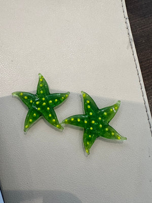 Miniature glass starfish figurine from SHOPGIVECOURAGE, decorative collectible sitting on a surface, detailed and transparent design.