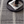 Black and white striped rug with a round tray holding magazines and a black square cup.