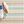 Handwoven cotton rug by AnS with blue and white Daphne Stripe Sky design, measuring 2x3 feet.