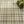 Green and cream plaid pattern with a wooden box of succulents in the top right corner.