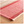 Red and beige checkered rug with a woven texture on a wooden floor.