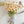 Colorful 22-inch silk poppy spray with flocked floral stem, featuring vibrant, realistic silk flowers and green foliage.