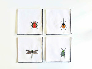 Set of four Dot and Army linen cocktail napkins with insect embroidery, elegant and decorative for dining or entertaining.