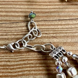 White onyx triple necklace from Nellie Pratt Artisan Jewelry featuring layered sterling silver chains and polished onyx stones.