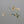 Colorful 22-inch silk poppy spray with flocked floral stem, showcasing vibrant silk flowers and green foliage for floral arrangements.