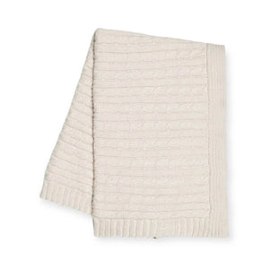 Cream knit scarf with a cable pattern and ribbed edges, folded neatly.