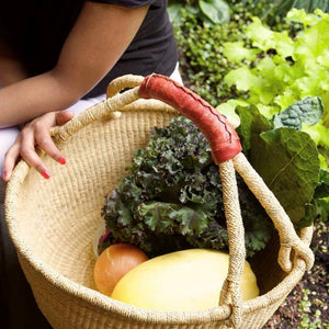 Dye-free African Bolga Ghana basket tote bag with woven handle, showcasing traditional craftsmanship and natural materials.
